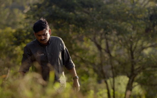 Joes Louies of the Wildlife Trust of India walks in a forst.